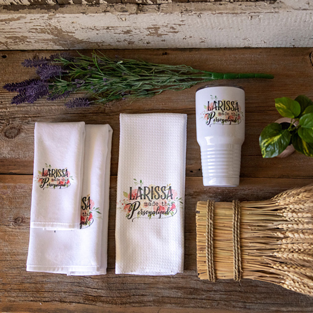 A collection of custom logo printed items, including a steel tumbler, kitchen towel, bathroom guest towel and matching hand towel.