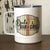 A white steel Camp Mug that says, "Dad's Bar & Grill...If you don't like the food, you're a dumbass"