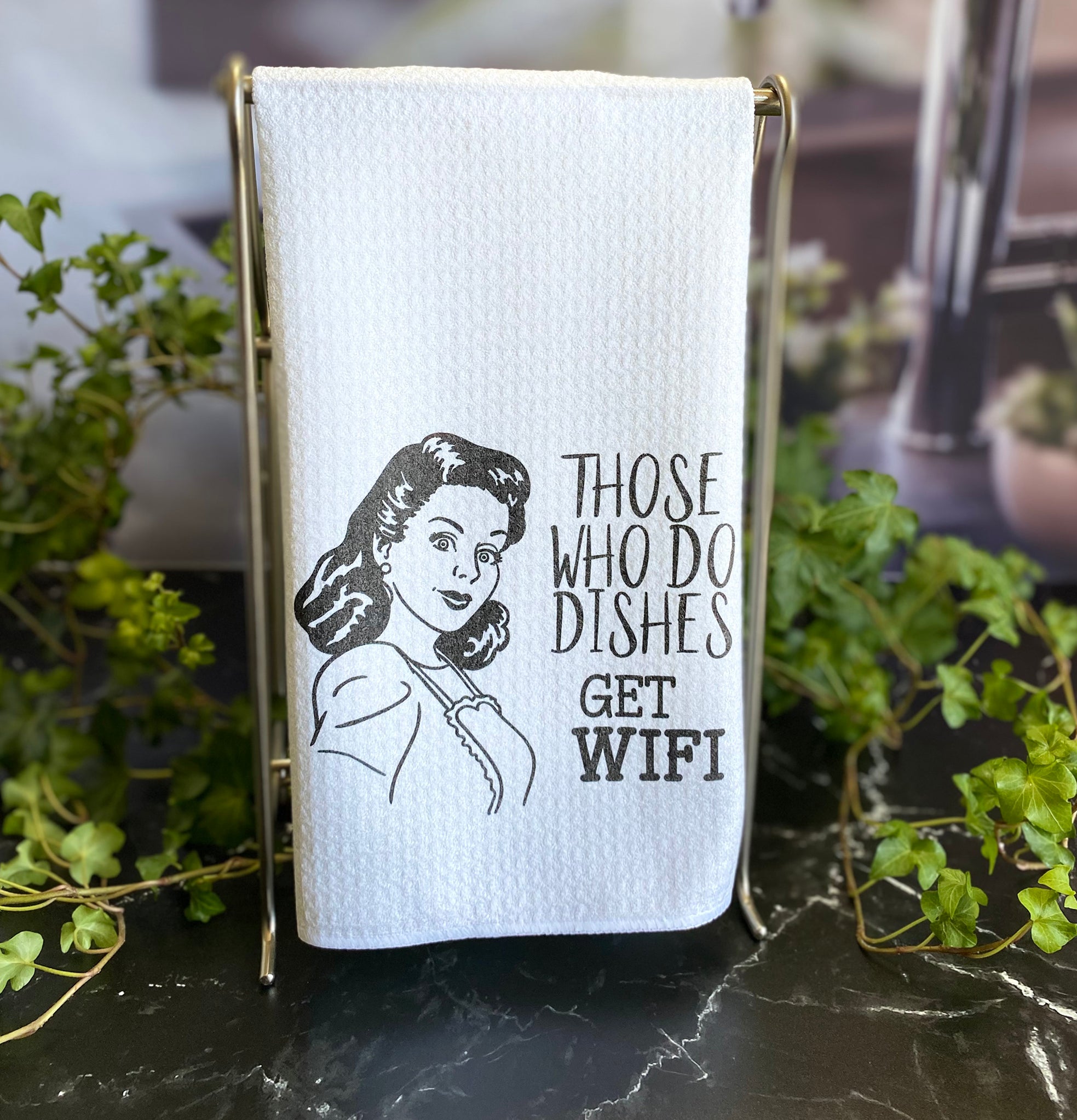 Dishtowel with a a black and white image of a hand drawn woman from the 1950's, with the words, "Those who do dishes get WIFI"