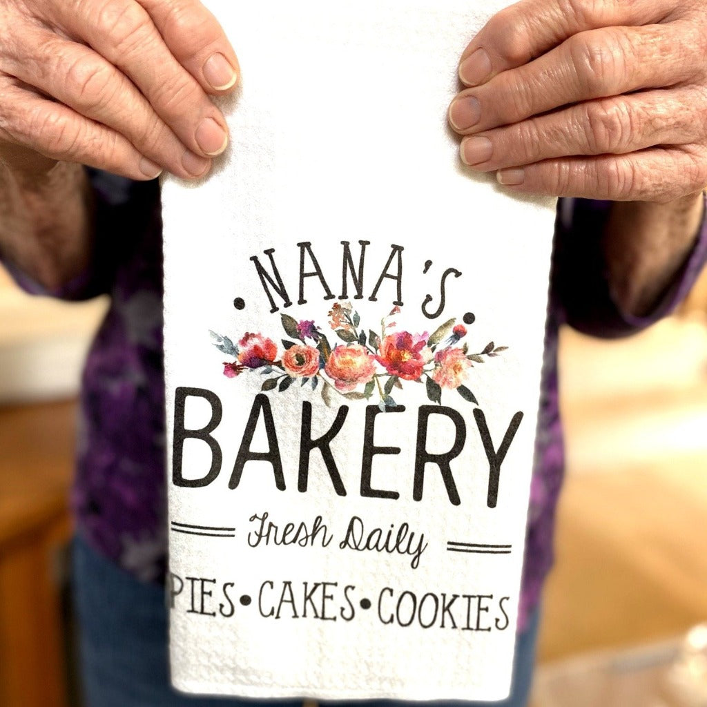 Nana's Bakery towel with a beautiful floral detail being held by  a wonderful Nana.