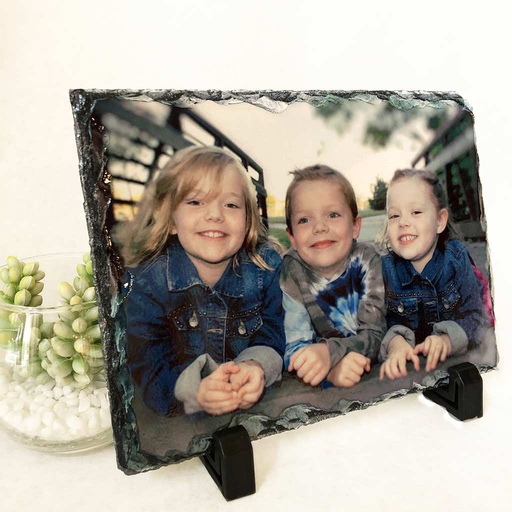 Photo slate with a photo of three smiling children